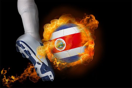 simsearch:400-07527960,k - Football player kicking flaming costa rica ball against black Stock Photo - Budget Royalty-Free & Subscription, Code: 400-07528541
