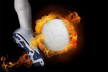 Football player kicking flaming ball against black Stock Photo - Budget Royalty-Free & Subscription, Code: 400-07528551