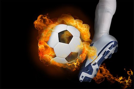 Football player kicking flaming ball against black Stock Photo - Budget Royalty-Free & Subscription, Code: 400-07528552