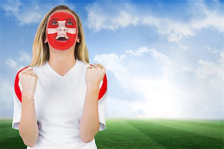 football faces paintings pictures - Excited fan in swiss face paint cheering against football pitch under blue sky Stock Photo - Budget Royalty-Free & Subscription, Code: 400-07528597