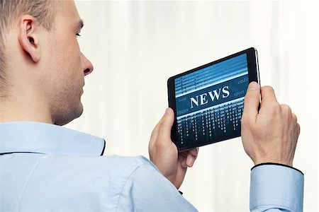 spaxiax (artist) - Man Holding Digital Tablet. News concept Photographie de stock - Aubaine LD & Abonnement, Code: 400-07528854