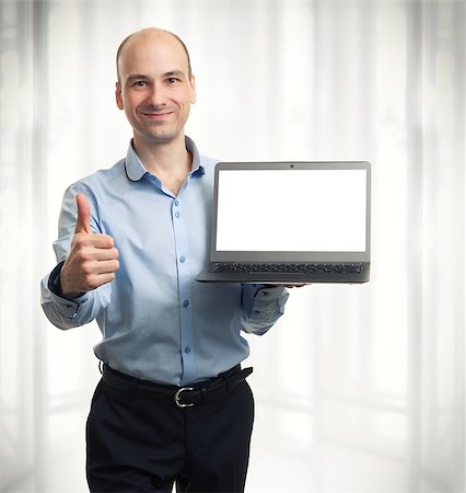 businessman showing blank laptop computer and thumbs up Foto de stock - Super Valor sin royalties y Suscripción, Código: 400-07528855