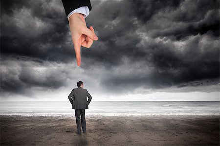 photos of ominous sea storms - Giant hand pointing at businessman with hands on hips against stormy weather by the sea Stock Photo - Budget Royalty-Free & Subscription, Code: 400-07528850