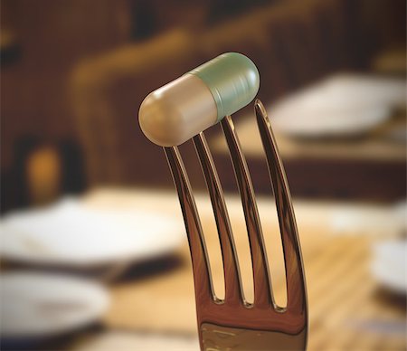Inside the restaurant with a pill stuck in the fork. Concept of food supplement. Stock Photo - Budget Royalty-Free & Subscription, Code: 400-07528976