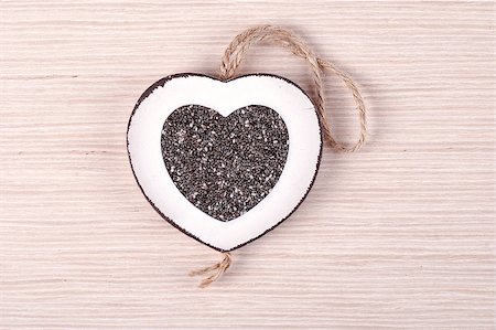 White heart shaped frame filled with chia seeds, on white oak wood. Stock Photo - Budget Royalty-Free & Subscription, Code: 400-07544852