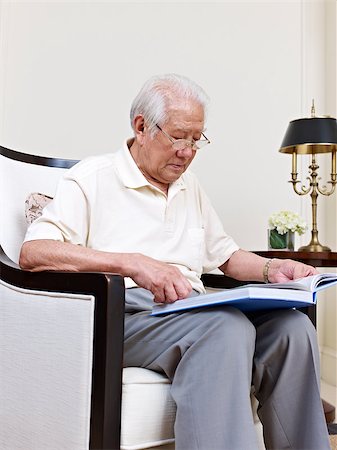 asian senior man sitting in an armchair and reading. Stock Photo - Budget Royalty-Free & Subscription, Code: 400-07545090