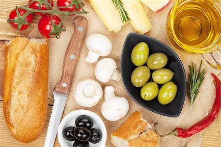simsearch:400-07481817,k - Olives, mushrooms, bread, vegetables and spices over cooking paper Stock Photo - Budget Royalty-Free & Subscription, Code: 400-07545246