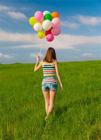 photo girl walking with balloon - Young beautiful woman with colorful balloons on a green meadow Stock Photo - Budget Royalty-Free & Subscription, Code: 400-07545659