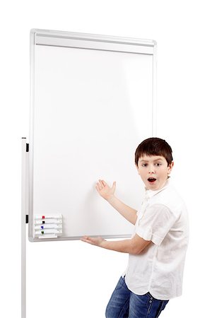 surprised young boy student in a classroom showing on a empty whiteboard Stock Photo - Budget Royalty-Free & Subscription, Code: 400-07546174