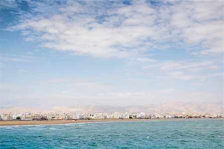 Image of a view to Sur in Oman with sea, mountains, houses and sky Foto de stock - Super Valor sin royalties y Suscripción, Código: 400-07546236