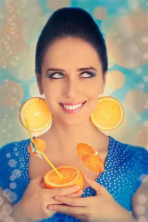 pop art of holding - Young woman with orange slice earrings holding a sliced orange with a straw, vintage portrait Stock Photo - Budget Royalty-Free & Subscription, Code: 400-07549495