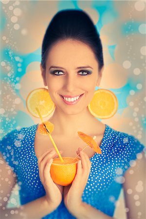 pop art of holding - Young woman with orange slice earrings holding a sliced orange with a straw, vintage portrait Stock Photo - Budget Royalty-Free & Subscription, Code: 400-07549496