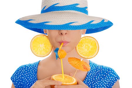 pop art of holding - Young woman with orange slice earrings drinking from an orange, wearing a straw hat, on a white background Stock Photo - Budget Royalty-Free & Subscription, Code: 400-07549497