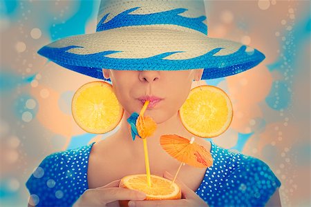 pop art of holding - Young woman with orange slice earrings drinking from an orange, wearing a straw hat, vintage portrait Stock Photo - Budget Royalty-Free & Subscription, Code: 400-07549498