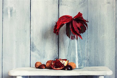 Photo of pomegranate, nuts and fall red leaves in vase Stock Photo - Budget Royalty-Free & Subscription, Code: 400-07549513