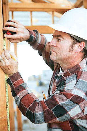 simsearch:400-07304331,k - Construction worker taking measurements on the job site. Stock Photo - Budget Royalty-Free & Subscription, Code: 400-07554263