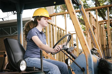 simsearch:400-08260997,k - Young female construction apprentice learning to drive heavy equipment. Fotografie stock - Microstock e Abbonamento, Codice: 400-07554273