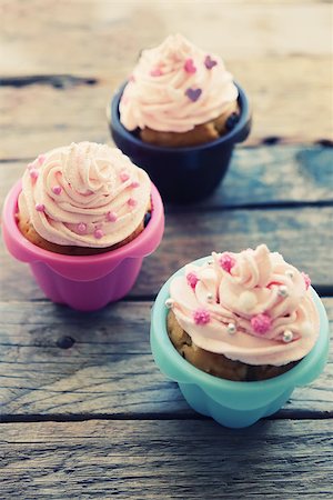 retro baking - Photo of cute cupcakes on wooden background Stock Photo - Budget Royalty-Free & Subscription, Code: 400-07554330