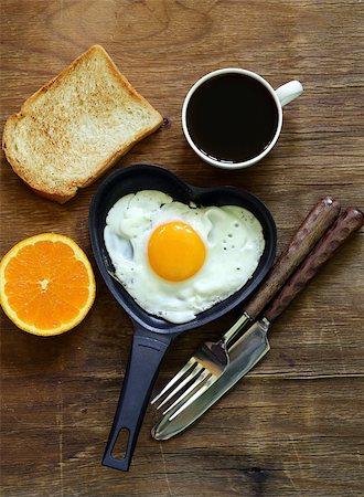fried egg with fresh orange, toast and coffee for breakfast Stock Photo - Budget Royalty-Free & Subscription, Code: 400-07555968