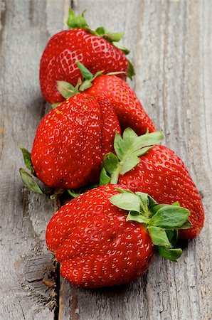 simsearch:400-08020671,k - Big Fresh Ripe Strawberries In a Row isolated on Rustic Wooden background Stock Photo - Budget Royalty-Free & Subscription, Code: 400-07556117