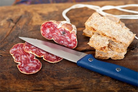 simsearch:400-06852716,k - slicing italian salame pressato pressed over old wood table Stockbilder - Microstock & Abonnement, Bildnummer: 400-07556796