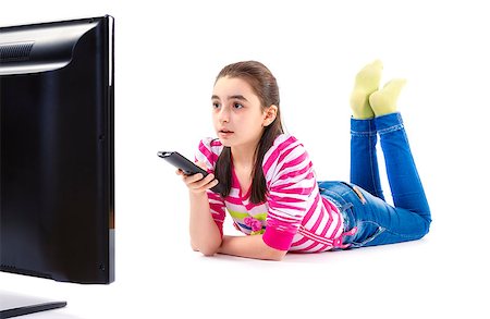 little girl watching LED tv laying on white background Stock Photo - Budget Royalty-Free & Subscription, Code: 400-07557805