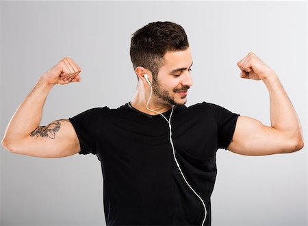 funny photos of biceps - Beautiful latin man listen music and appreciate his own muscles Stock Photo - Budget Royalty-Free & Subscription, Code: 400-07558118