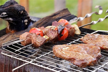 Cooking on the barbecue grill assortment sausages steak and skewers Stock Photo - Budget Royalty-Free & Subscription, Code: 400-07551168