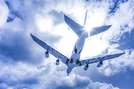 abstract of a large passenger jet landing through blue toned clouds Stock Photo - Budget Royalty-Free & Subscription, Code: 400-07553175