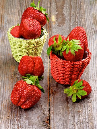 simsearch:400-08020671,k - Ripe Strawberries in Colorful Wicker Baskets isolated on Wooden background Stock Photo - Budget Royalty-Free & Subscription, Code: 400-07553195