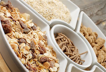 simsearch:400-08152810,k - Muesli with Raisins and Nuts, Oat Flakes and Bran in White Plates closeup on Wooden background Photographie de stock - Aubaine LD & Abonnement, Code: 400-07553191