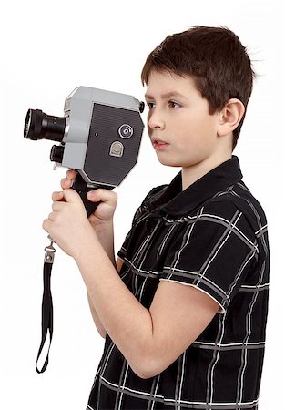 film making - young boy with old vintage analog 8mm camera looking to viewfinder Stock Photo - Budget Royalty-Free & Subscription, Code: 400-07553457