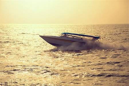 driving a cruise ship - Motor boat on sunset, vintage toned image Stock Photo - Budget Royalty-Free & Subscription, Code: 400-07553510