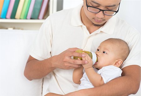 feeding asian family - Father bottle feeding baby fruits puree. Asian family lifestyle at home. Stock Photo - Budget Royalty-Free & Subscription, Code: 400-07553704