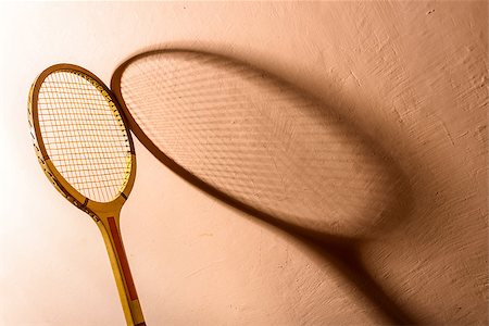 Backlit vintage tennis racket and its shadow on a pink background Stock Photo - Budget Royalty-Free & Subscription, Code: 400-07567517