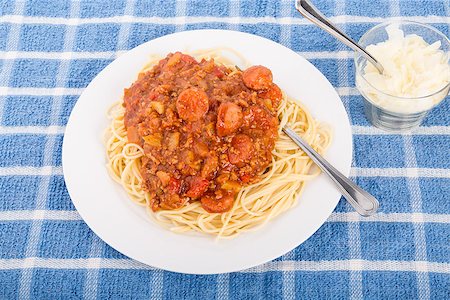 Spaghetti with a sauce of beef, tomatoes and sausage and shaved parmesan cheese on the side Stock Photo - Budget Royalty-Free & Subscription, Code: 400-07567576