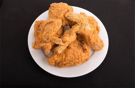 fried chicken plate - A white plate of fried chicken on a black background Stock Photo - Budget Royalty-Free & Subscription, Code: 400-07568090