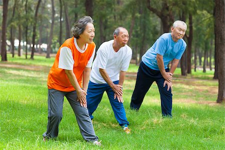 Seniors are warming up before jogging in the park Stock Photo - Budget Royalty-Free & Subscription, Code: 400-07568474