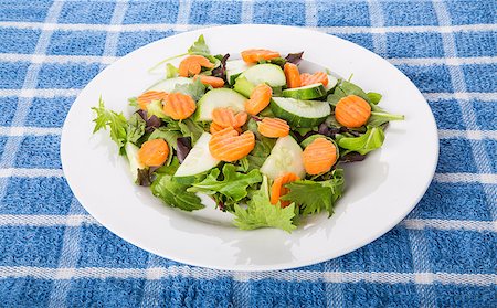dbvirago (artist) - A fresh salad of greens, cucumber, and carrots in a white plate Fotografie stock - Microstock e Abbonamento, Codice: 400-07568697