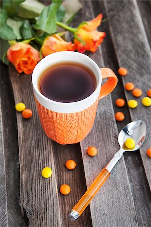 Cup of fresh black tea and colorful candies on the wooden table Stock Photo - Budget Royalty-Free & Subscription, Code: 400-07569658
