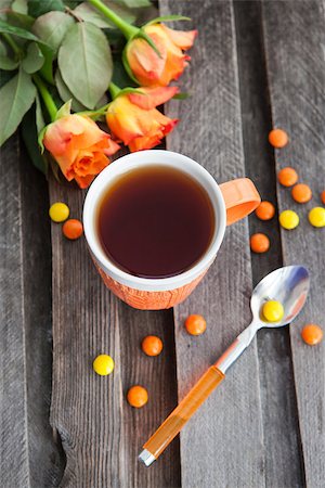 Cup of fresh black tea and colorful candies on the wooden table Stock Photo - Budget Royalty-Free & Subscription, Code: 400-07569659
