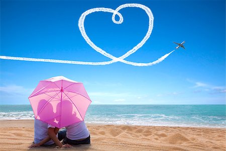 simsearch:400-06751687,k - young couple romantic kissing at the beach with the umbrella Stock Photo - Budget Royalty-Free & Subscription, Code: 400-07569852