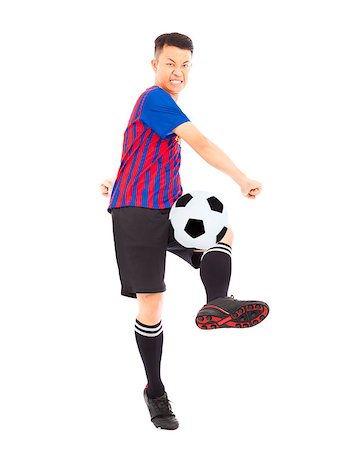 simsearch:400-04325504,k - Young soccer player kicking ball Fotografie stock - Microstock e Abbonamento, Codice: 400-07569862