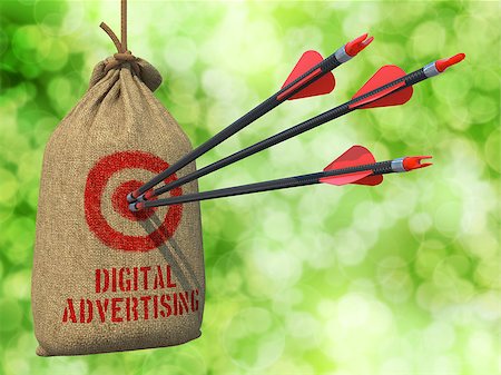 simsearch:400-07745360,k - Digital Advertising - Three Arrows Hit in Red Target on a Hanging Sack on Green Bokeh Background. Photographie de stock - Aubaine LD & Abonnement, Code: 400-07574345
