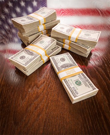 franklin - Thousands of Dollars Stacked with Reflection of American Flag on Wooden Table. Stock Photo - Budget Royalty-Free & Subscription, Code: 400-07574810