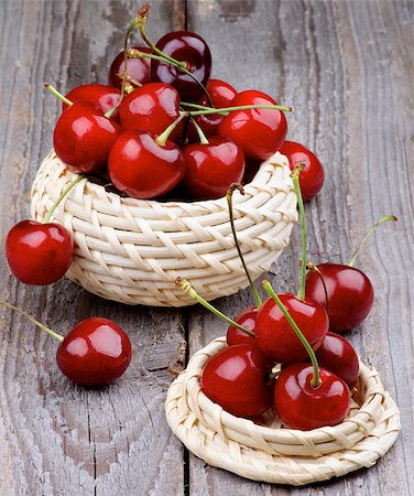 simsearch:400-08020671,k - Ripe Sweet Cherries in Wicker Bowls isolated on Rustic Wooden background Stock Photo - Budget Royalty-Free & Subscription, Code: 400-07575882