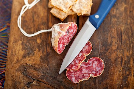 simsearch:400-06852716,k - slicing italian salame pressato pressed over old wood table Stockbilder - Microstock & Abonnement, Bildnummer: 400-07576014