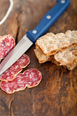 simsearch:400-06852716,k - slicing italian salame pressato pressed over old wood table Stockbilder - Microstock & Abonnement, Bildnummer: 400-07576015