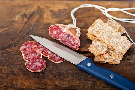 simsearch:400-06852716,k - slicing italian salame pressato pressed over old wood table Stockbilder - Microstock & Abonnement, Bildnummer: 400-07576013