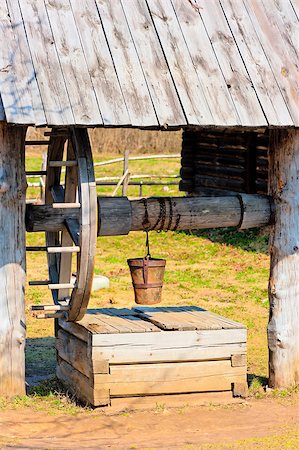 outdated wooden well with large wheel Stock Photo - Budget Royalty-Free & Subscription, Code: 400-07576056